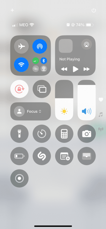An iPhone Control Center showing various toggles and controls.
